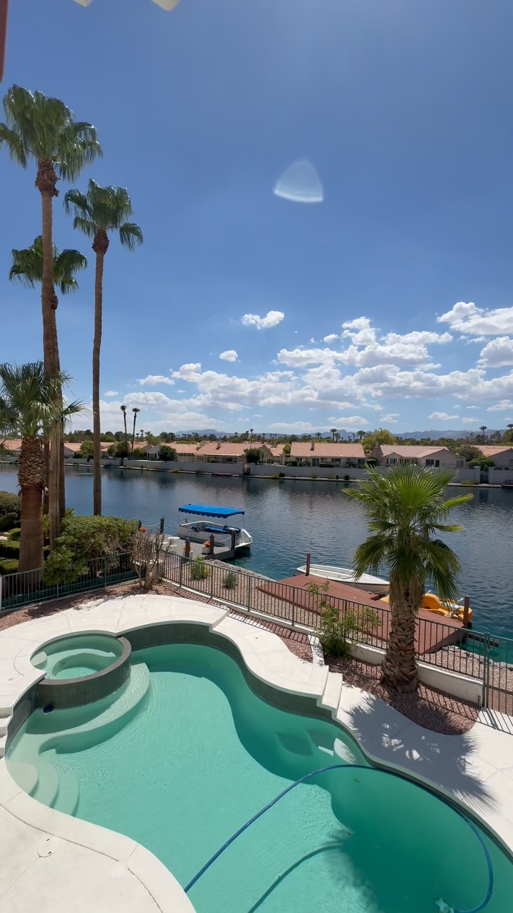 Desert Shores lakefront primary suite with a lake-view balcony — video tour